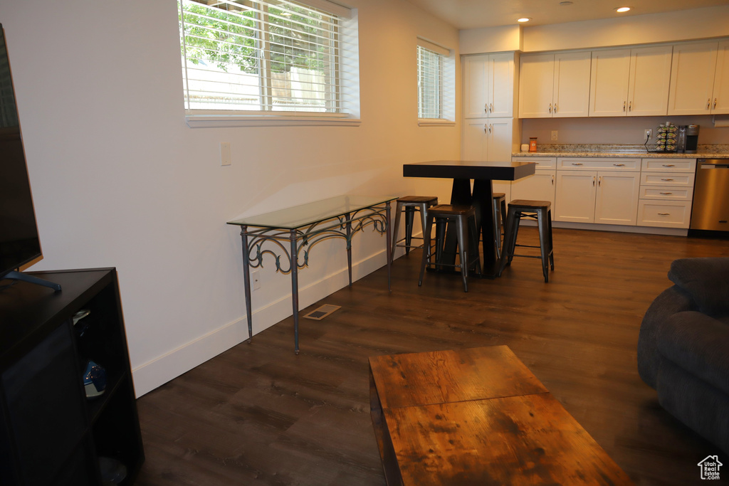 Kitchen featuring dishwasher, white cabinetry, baseboards, dark wood finished floors, and recessed lighting