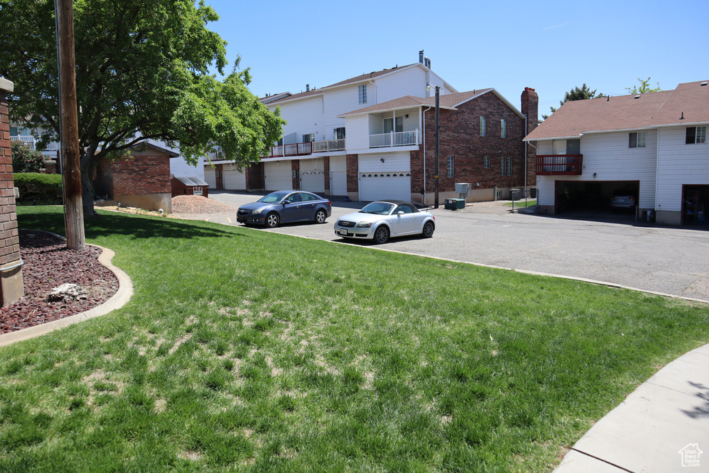 View of grassy yard with an attached garage