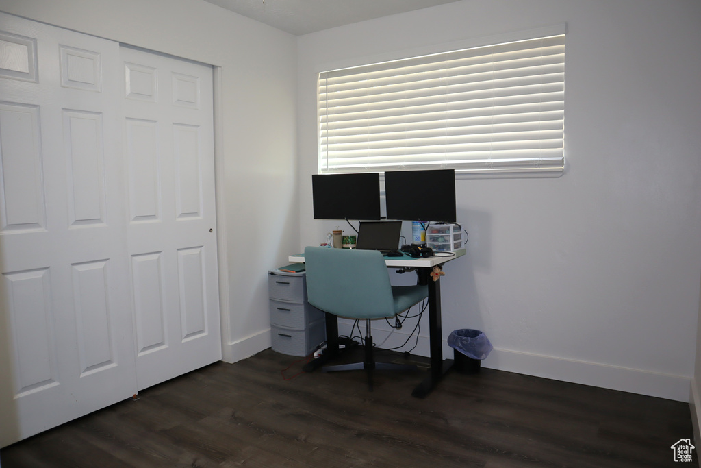 Home office featuring dark wood finished floors and baseboards