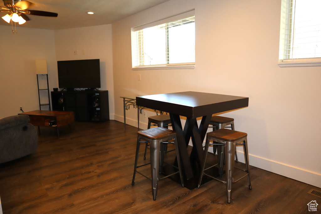 Dining area with dark wood-style floors, baseboards, a ceiling fan, and recessed lighting