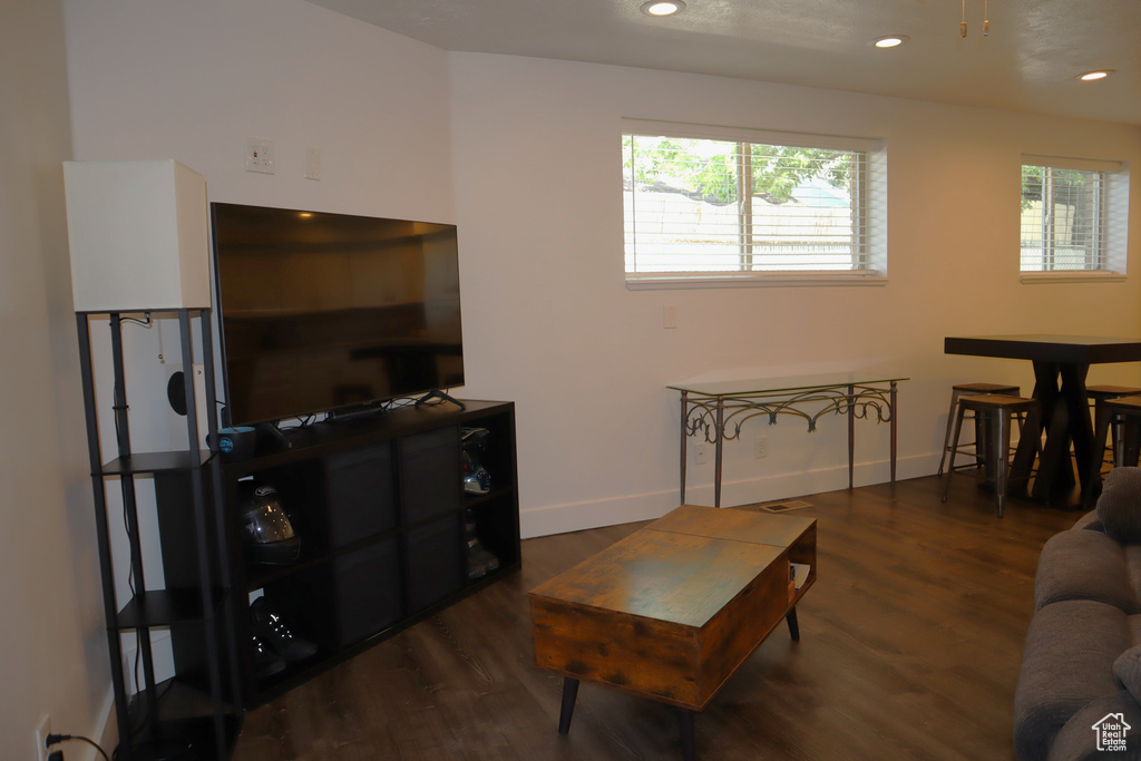 Living area featuring healthy amount of natural light, wood finished floors, baseboards, and recessed lighting