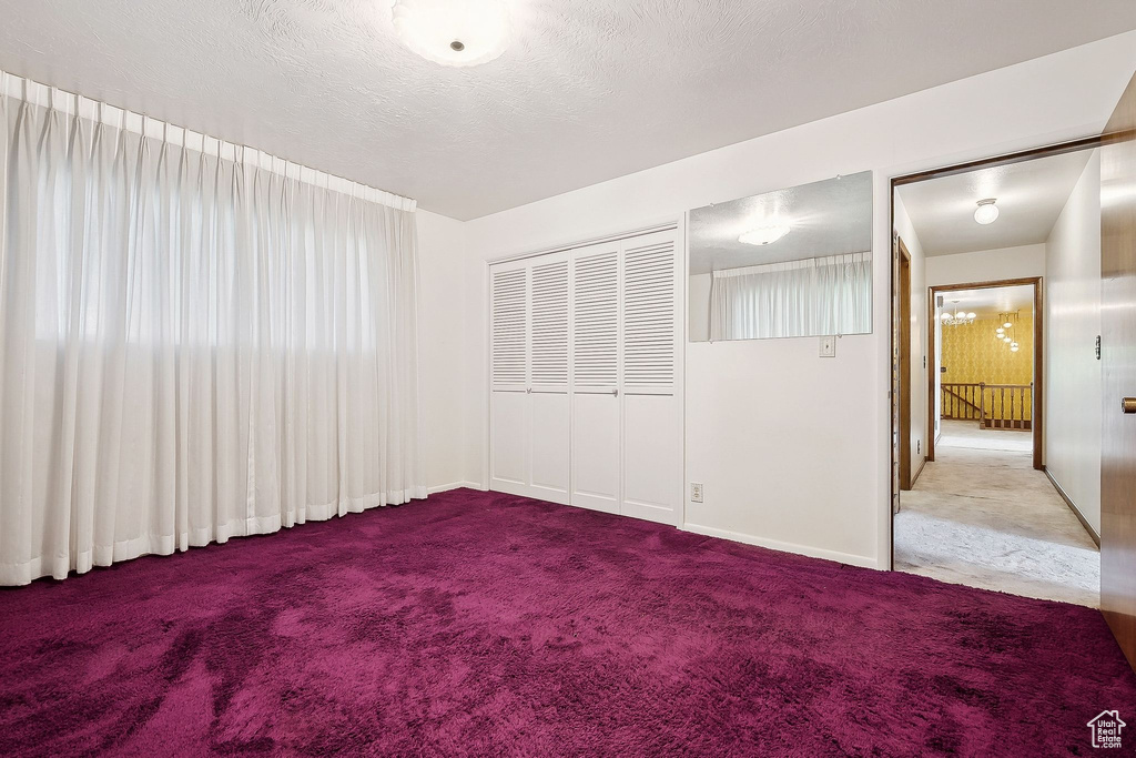 Carpeted spare room with baseboards
