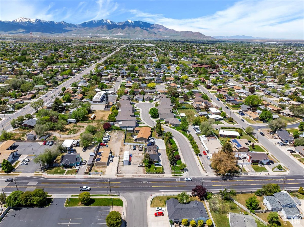 Aerial view of property's location featuring mountains and nearby suburban area
