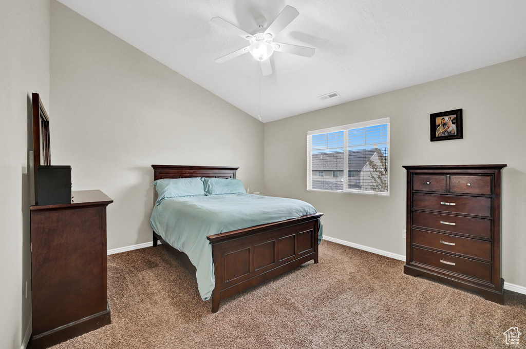 Bedroom with lofted ceiling, baseboards, and carpet floors