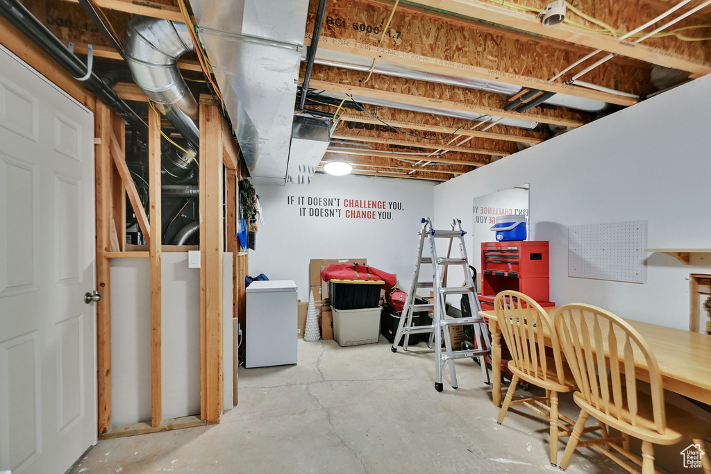 Unfinished basement with fridge