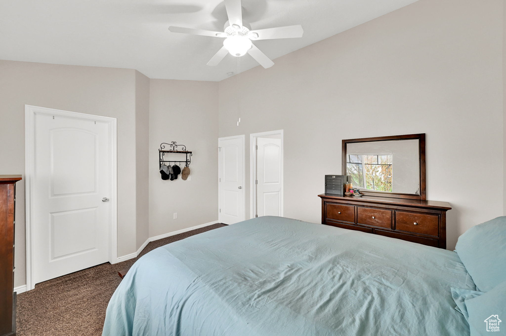 Bedroom with carpet floors, baseboards, ceiling fan, and lofted ceiling