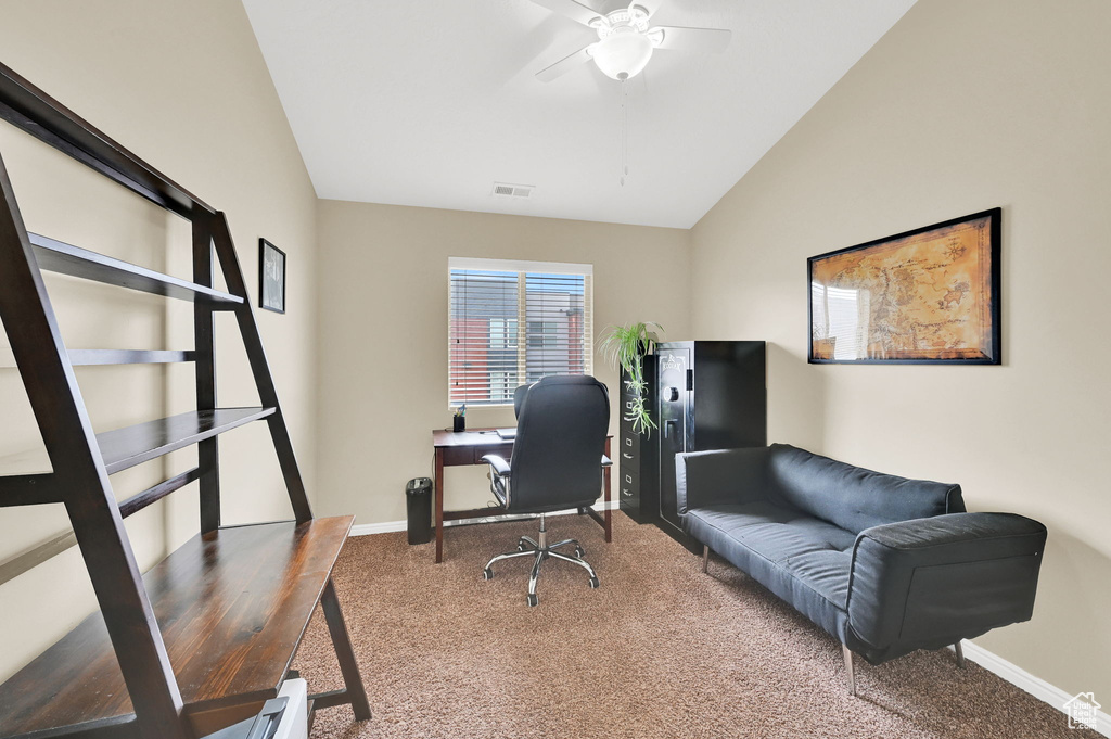 Office area featuring carpet, a ceiling fan, baseboards, and lofted ceiling