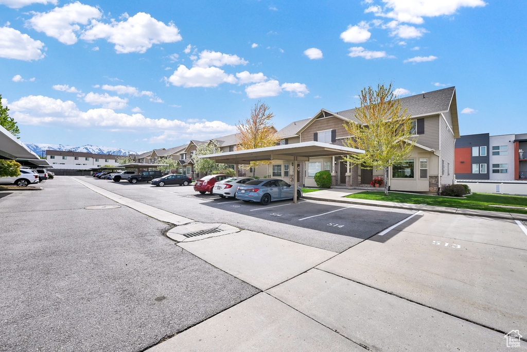 Partially covered parking lot featuring a residential view