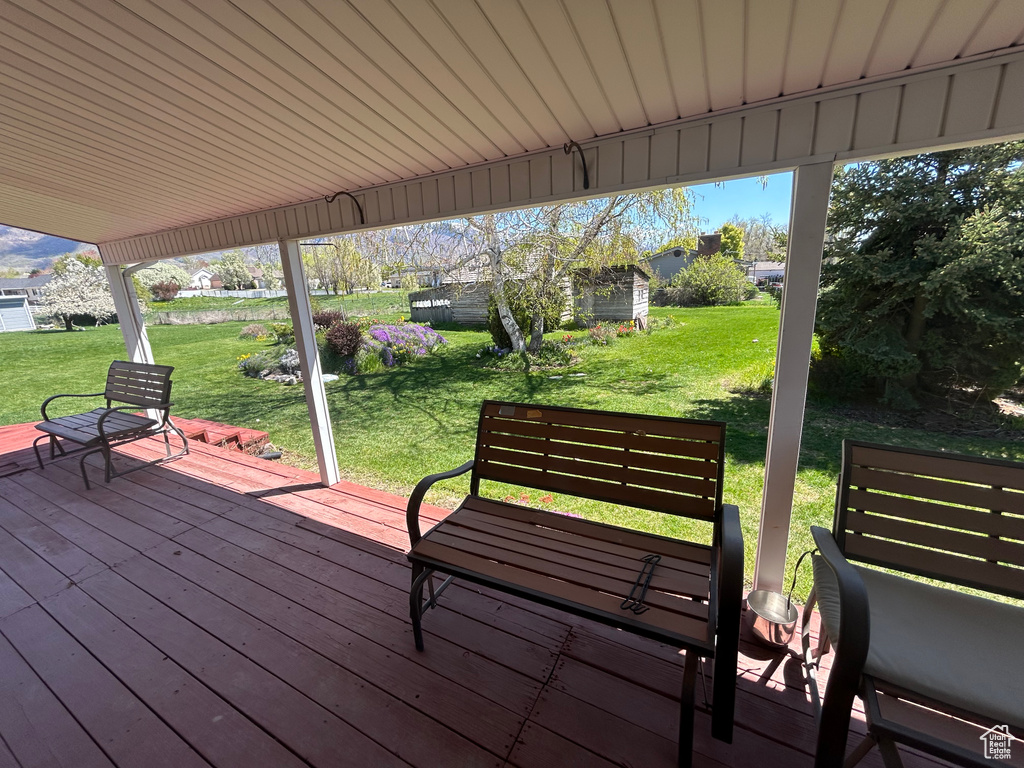 Wooden deck featuring a yard