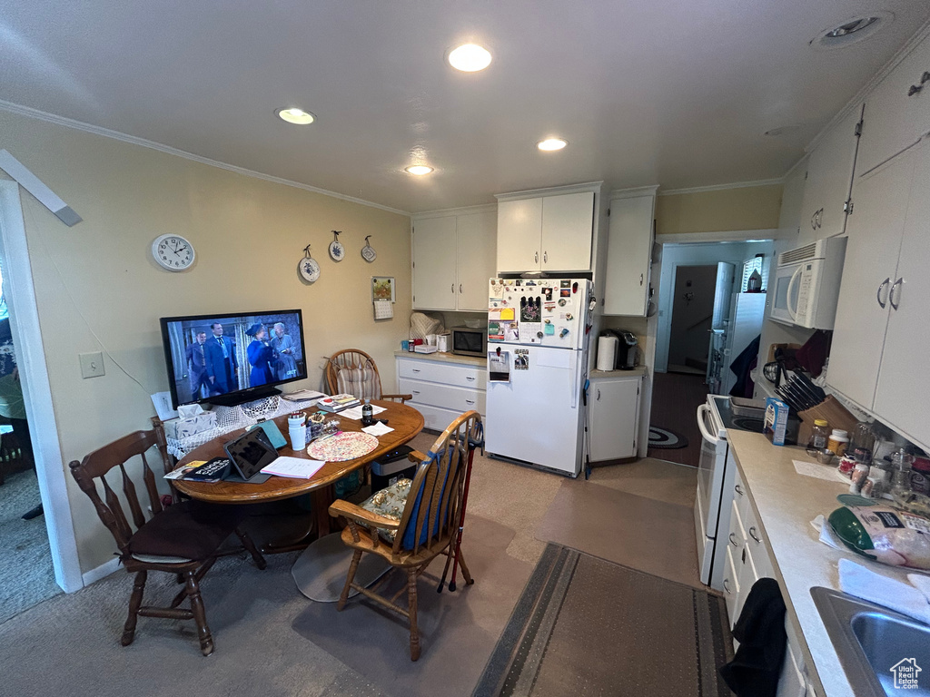 Dining room featuring ornamental molding and recessed lighting