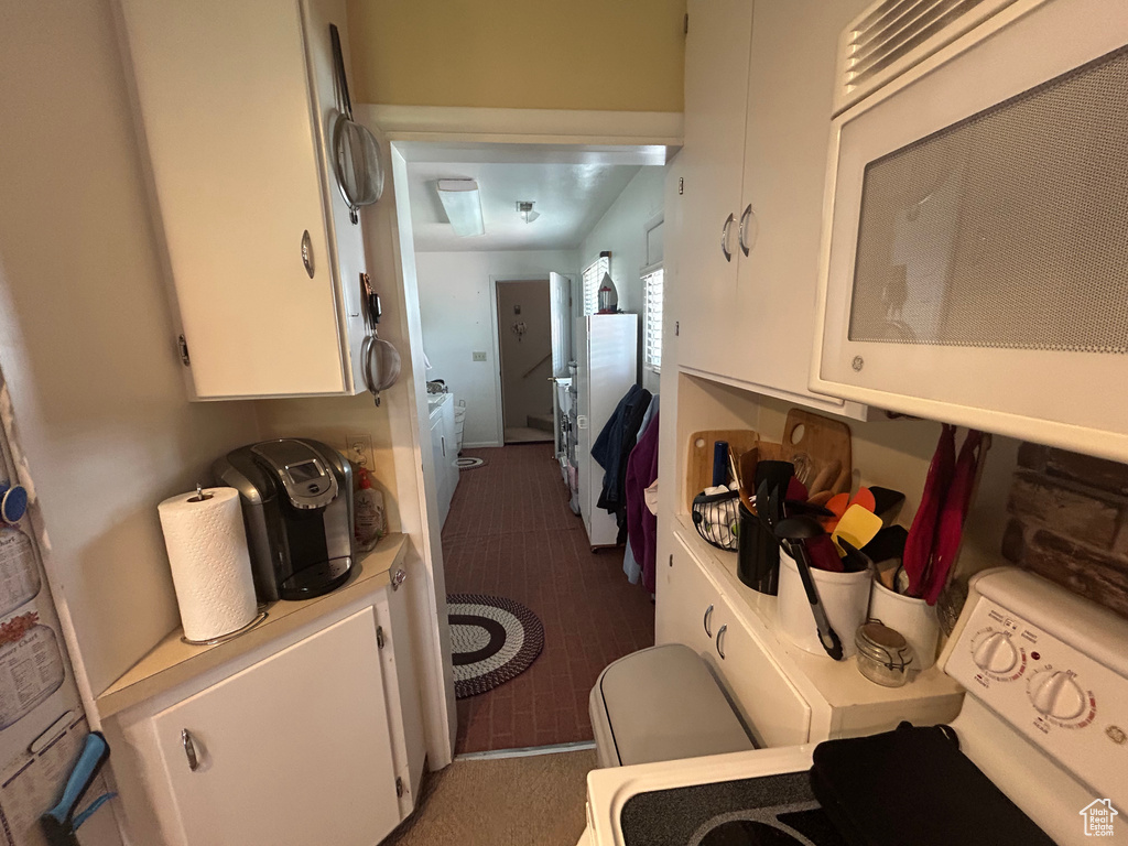 Bathroom with washer / dryer and tile patterned flooring