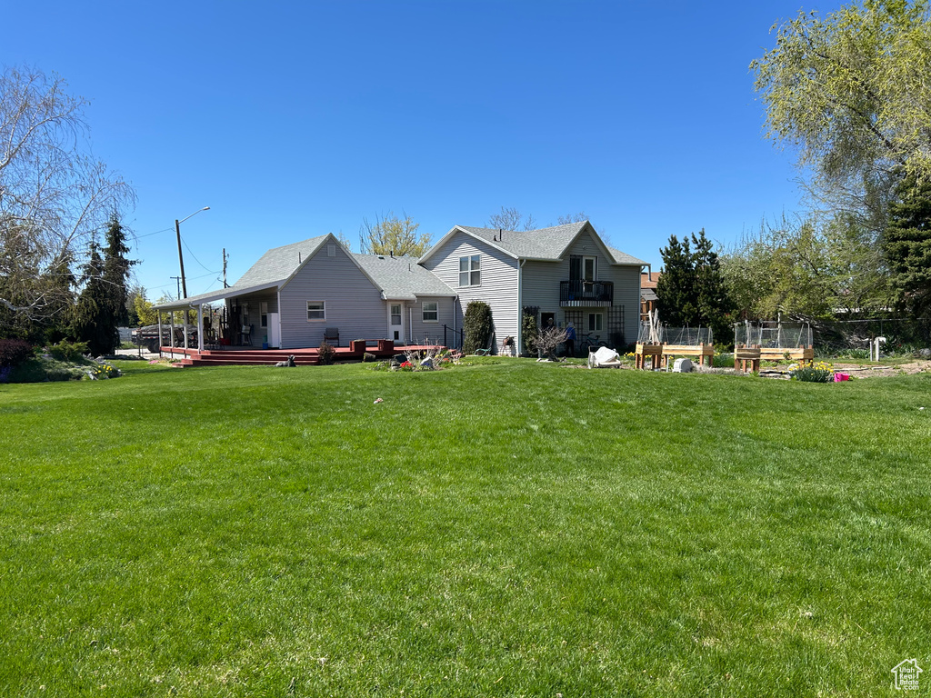 Back of house featuring a yard