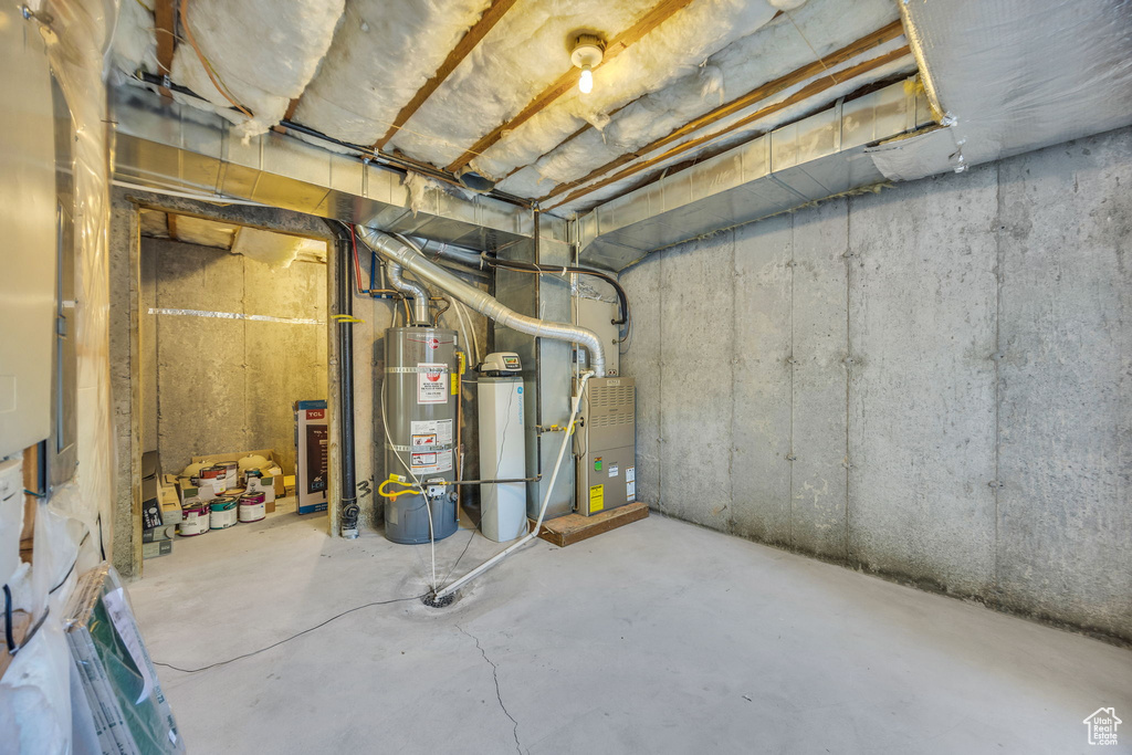 Unfinished below grade area featuring gas water heater
