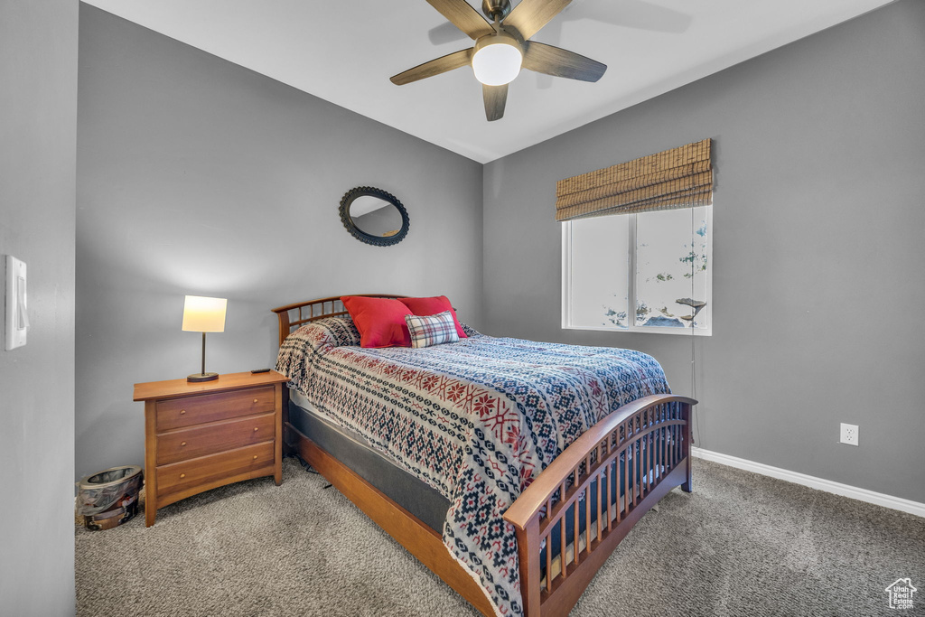 Bedroom featuring carpet flooring, baseboards, and a ceiling fan