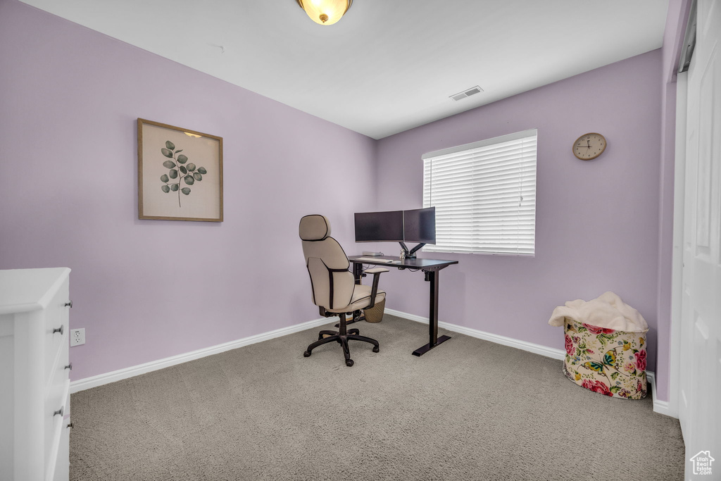 Carpeted office featuring baseboards