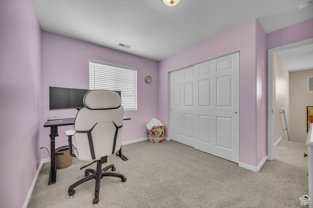 Carpeted office space featuring baseboards