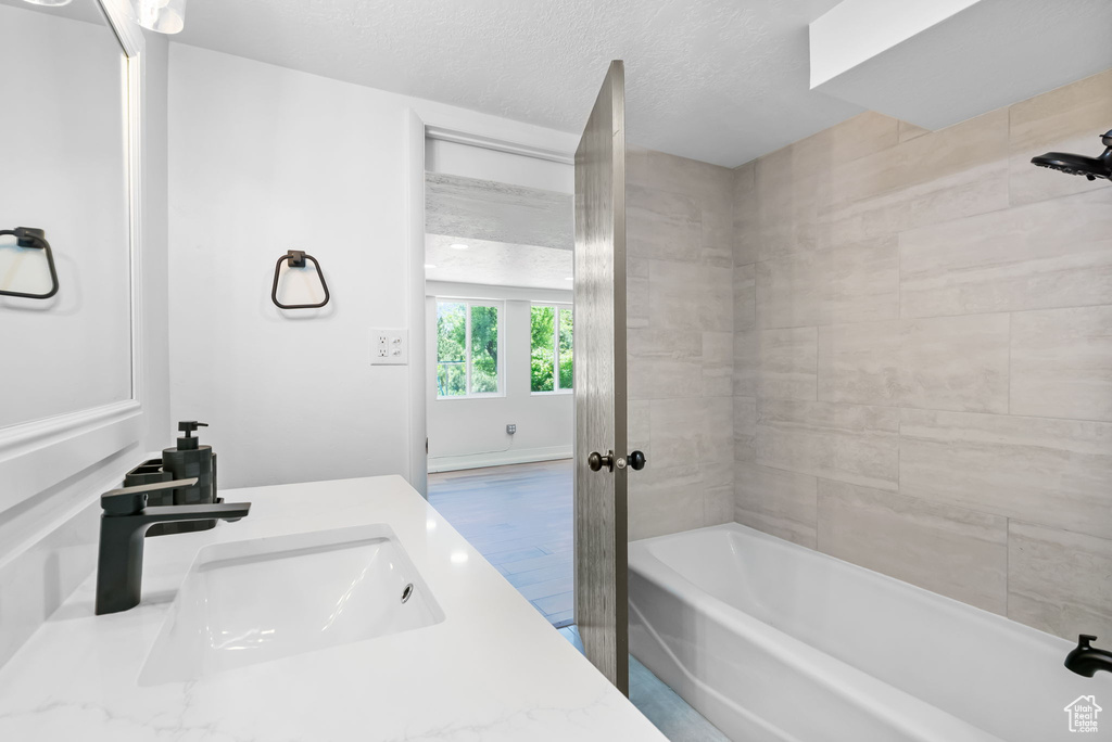 Bathroom featuring a textured ceiling and vanity