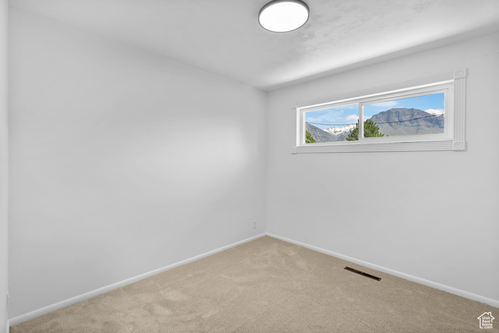 Empty room with carpet flooring and baseboards