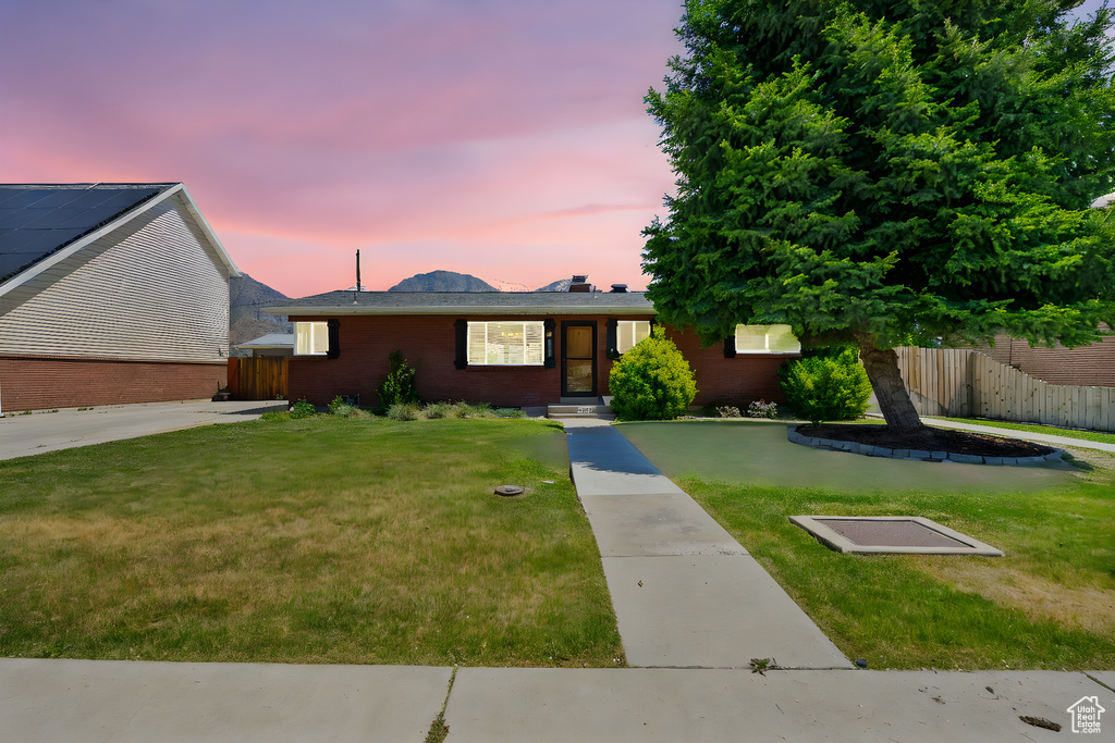Ranch-style house featuring brick siding