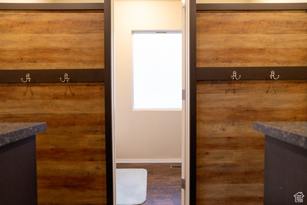 Bathroom with vanity, baseboards, and wood finished floors