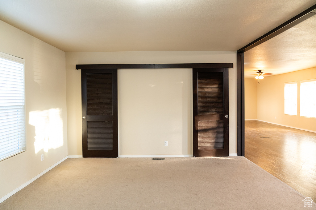 Unfurnished bedroom featuring baseboards and carpet floors