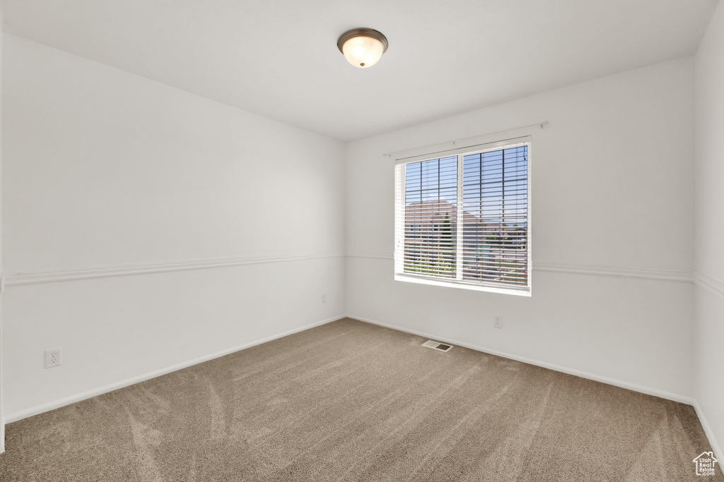 Empty room featuring carpet floors and baseboards