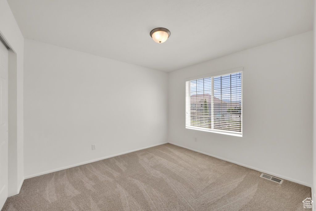 Unfurnished room featuring carpet and baseboards