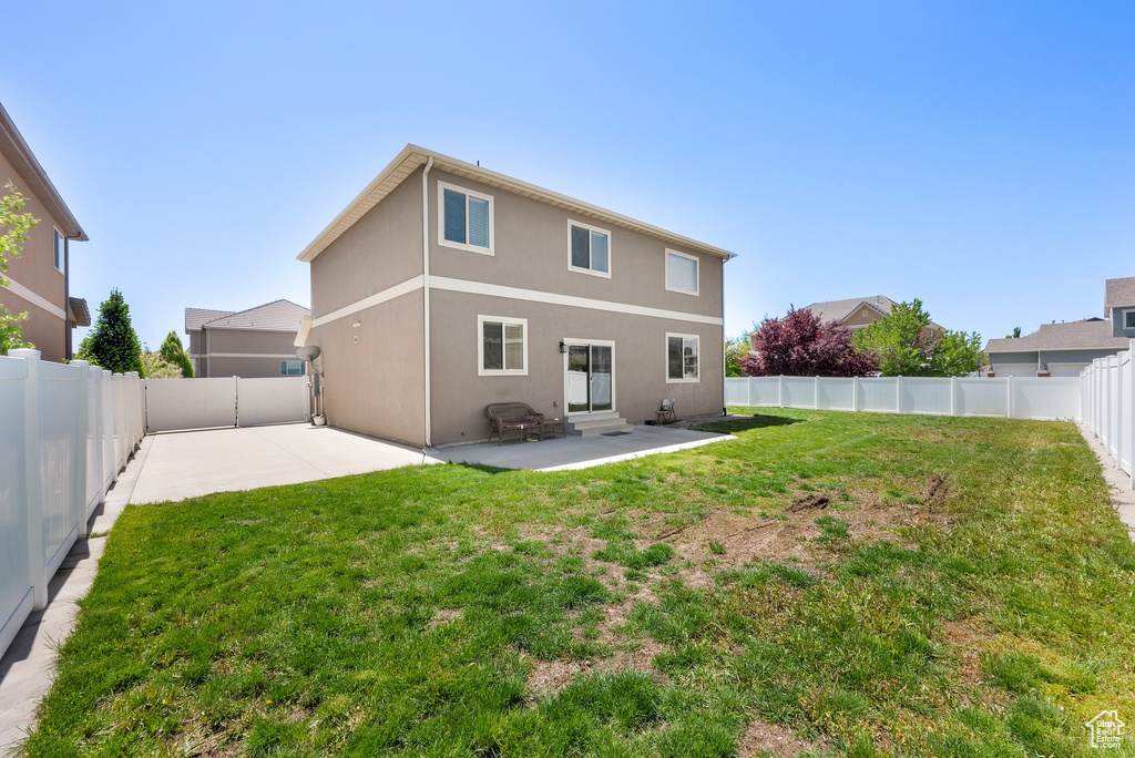 Rear view of house featuring a patio, stucco siding, and entry steps