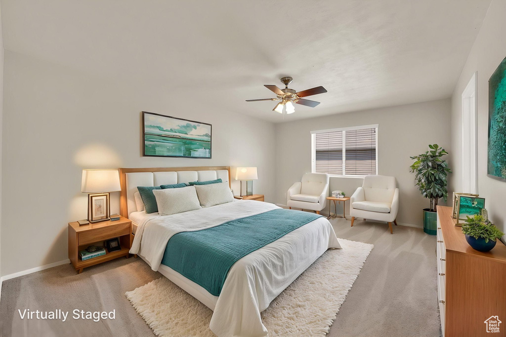 Carpeted bedroom with baseboards and ceiling fan