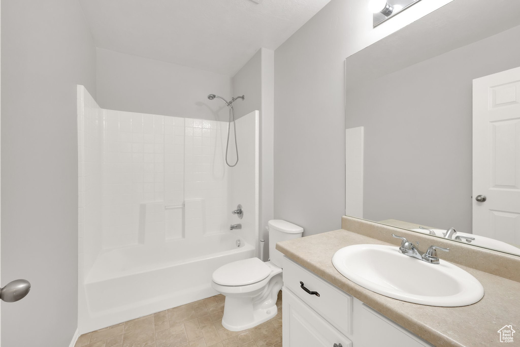 Bathroom featuring toilet, vanity, and bathing tub / shower combination
