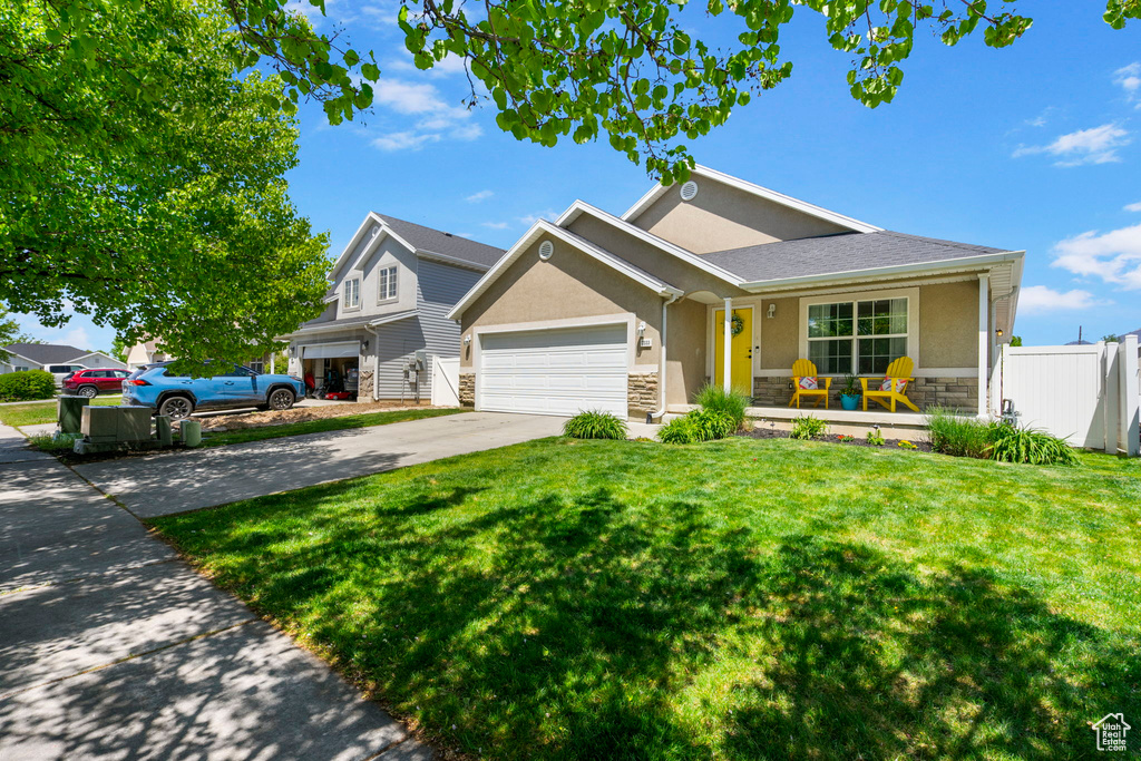Ranch-style house featuring stone siding, stucco siding, driveway, and a garage