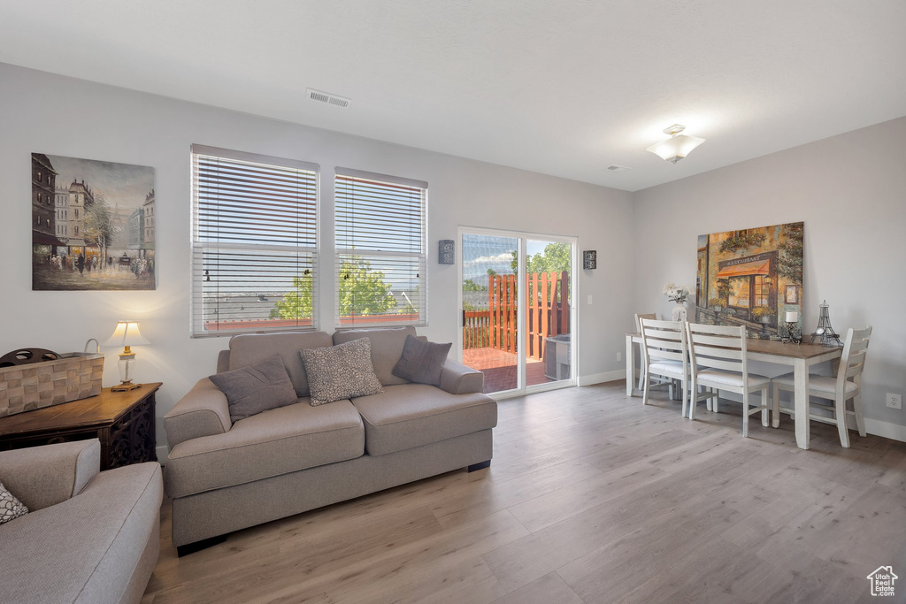 Living area with light wood-type flooring and baseboards