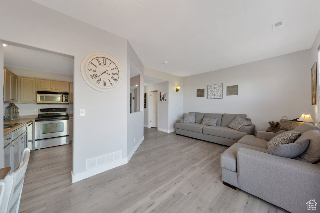 Living area featuring light wood finished floors and baseboards