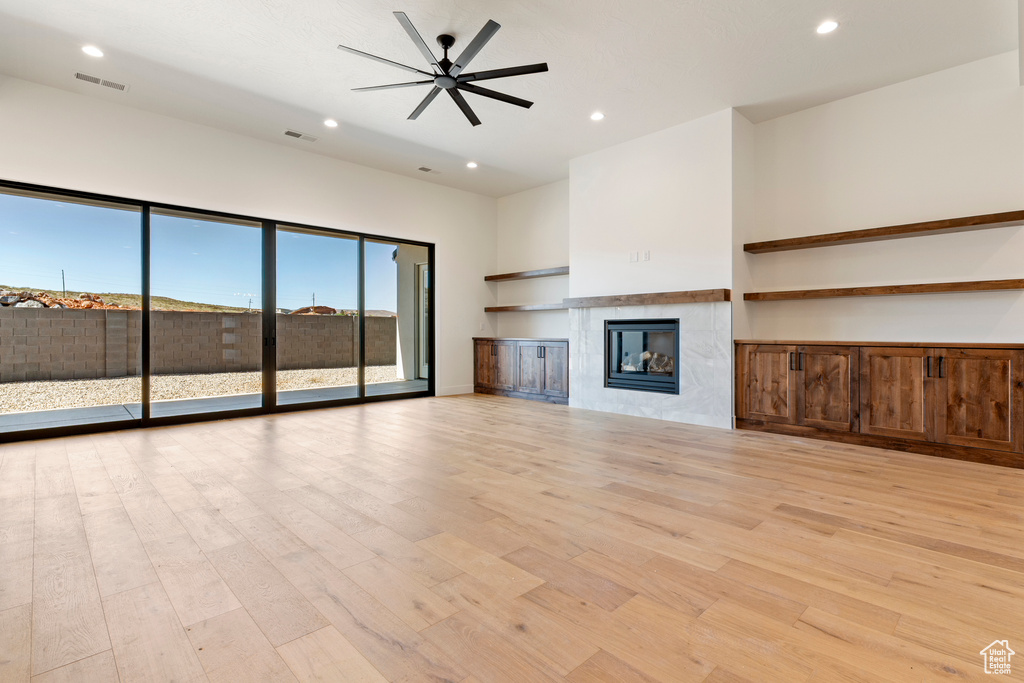 Unfurnished living room with recessed lighting, light wood-type flooring, a fireplace, and ceiling fan