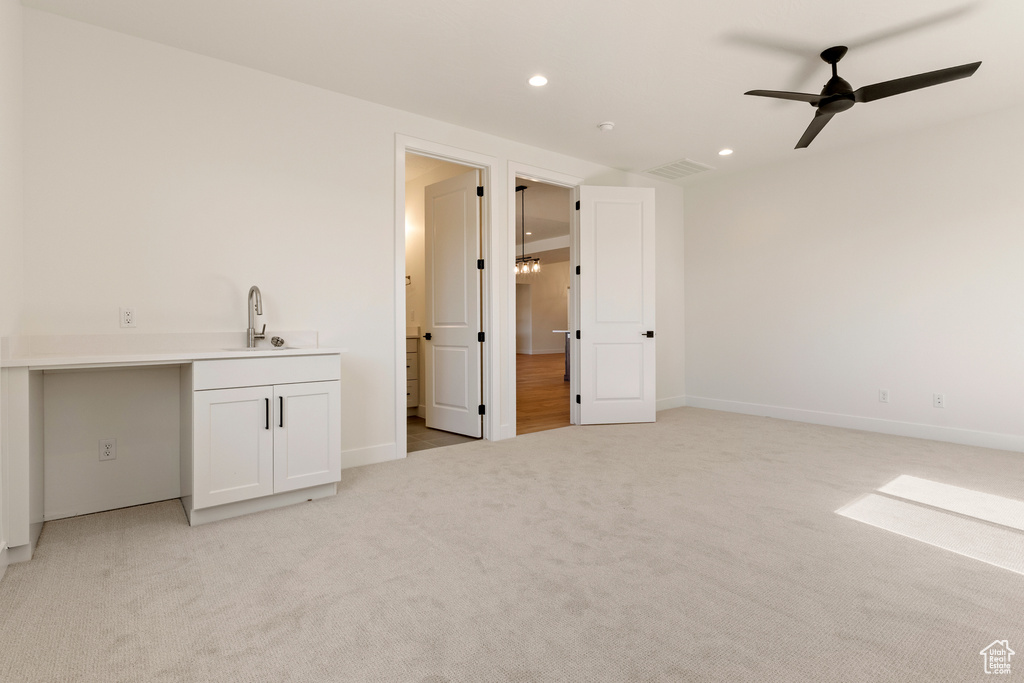 Bar featuring a sink, ceiling fan, recessed lighting, light colored carpet, and baseboards