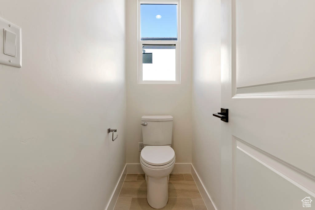 Bathroom with toilet and baseboards