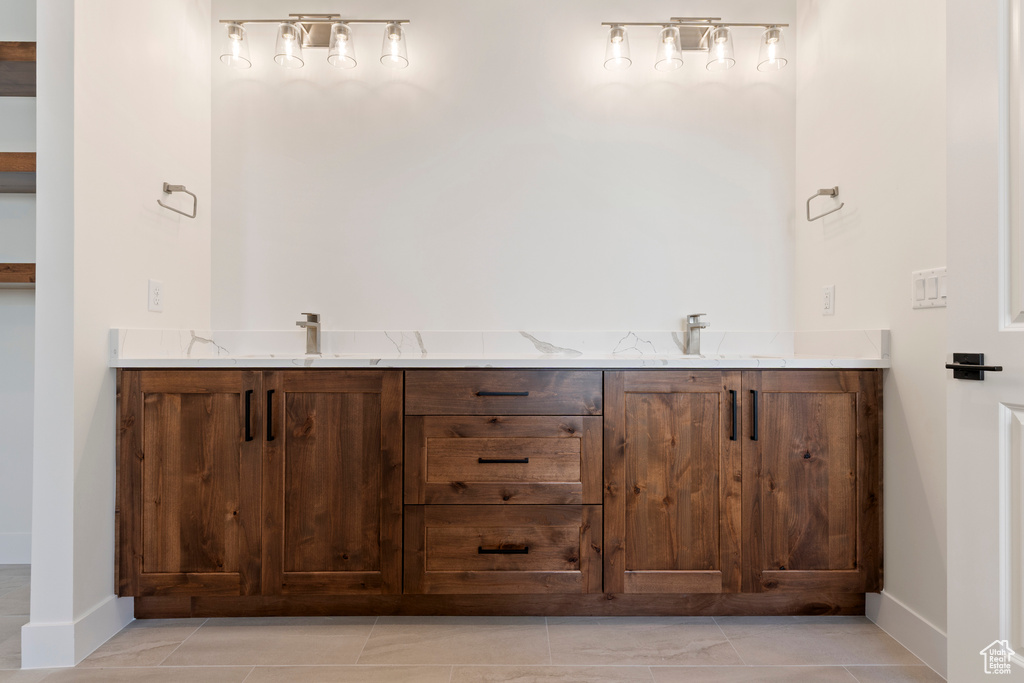 Bathroom featuring baseboards and double vanity