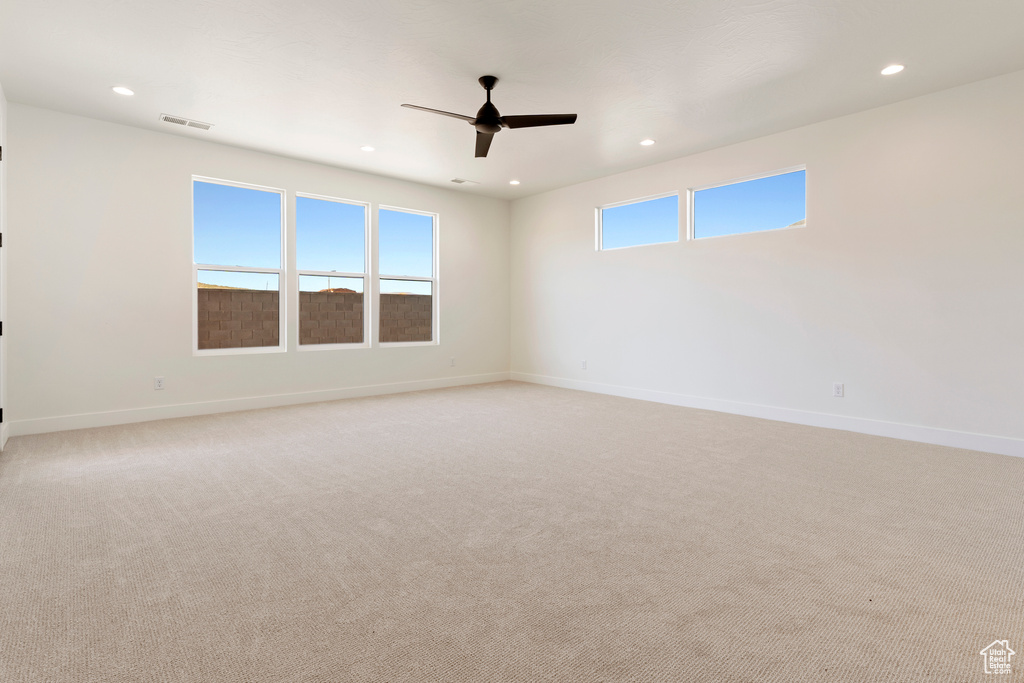 Empty room with recessed lighting, ceiling fan, baseboards, and light colored carpet