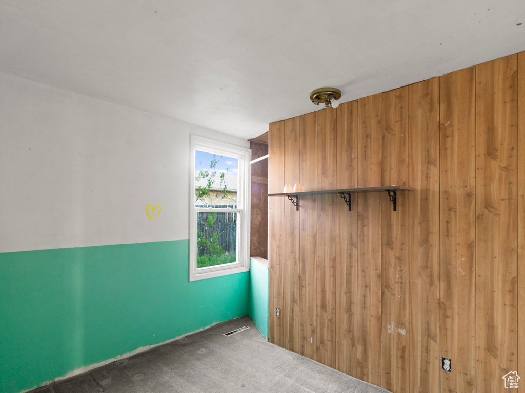 Spare room with wood walls