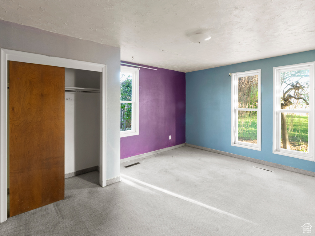 Unfurnished bedroom featuring baseboards and a closet
