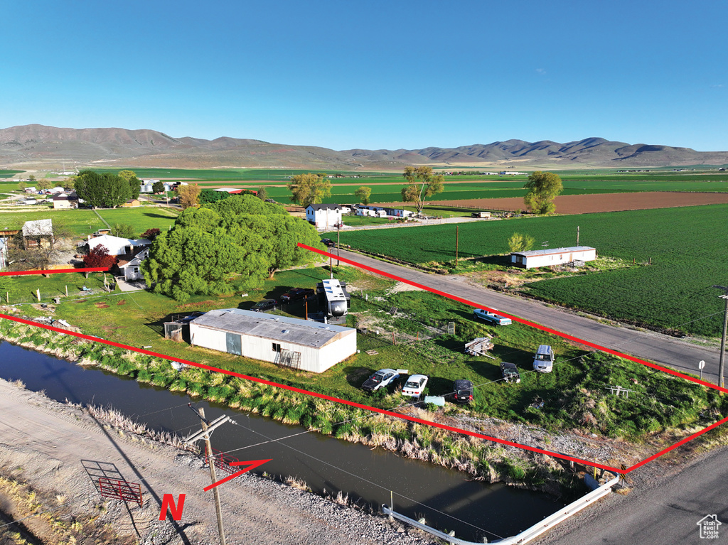 Overview of rural landscape with property parcel outlined and mountains