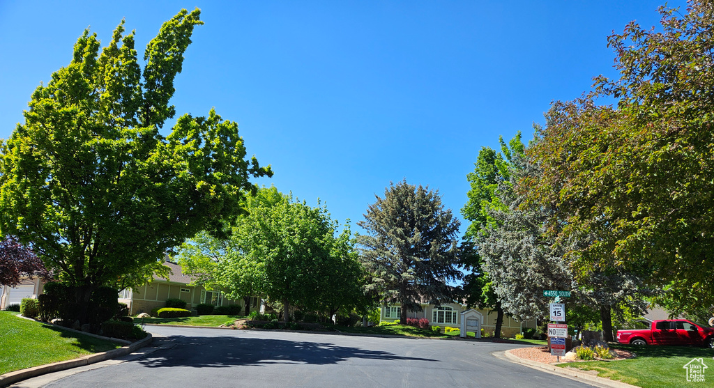 View of asphalt road with curbs and a residential view