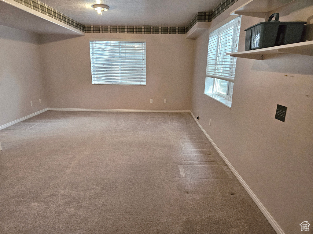 Unfurnished room featuring carpet flooring and baseboards