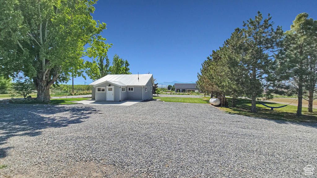 View of front of home with gravel driveway