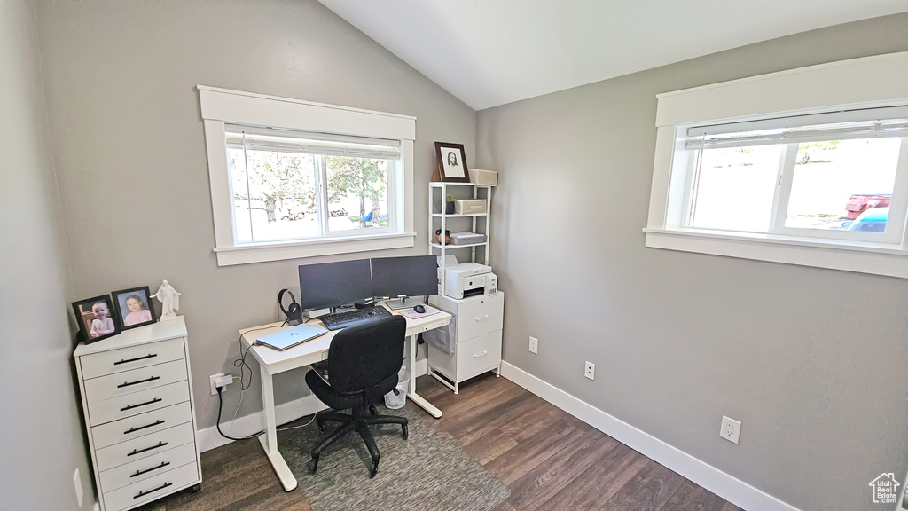 Office area with dark wood-type flooring, lofted ceiling, and baseboards