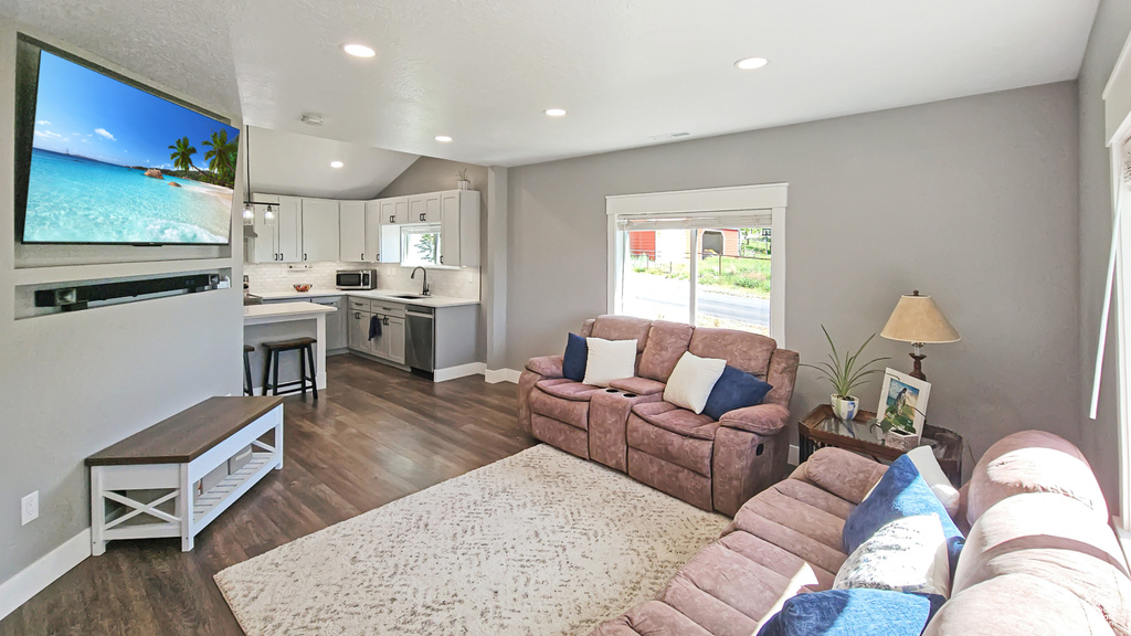 Living area featuring recessed lighting, baseboards, and dark wood finished floors