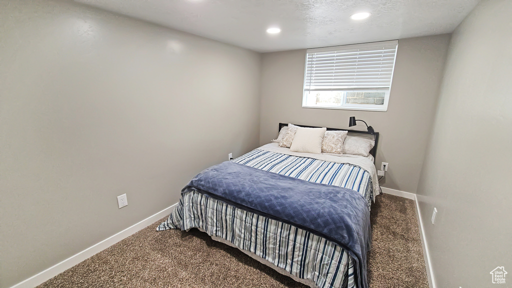 Bedroom featuring baseboards, carpet floors, and recessed lighting