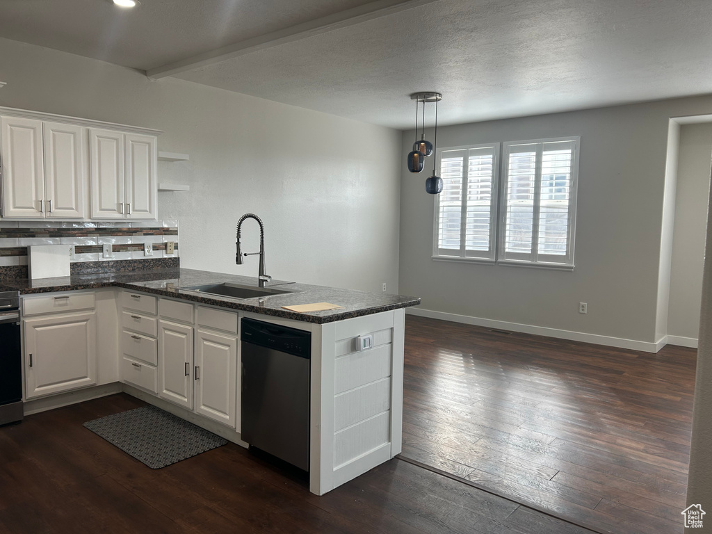 Kitchen featuring stainless steel dishwasher, a sink, a peninsula, open shelves, and white cabinets