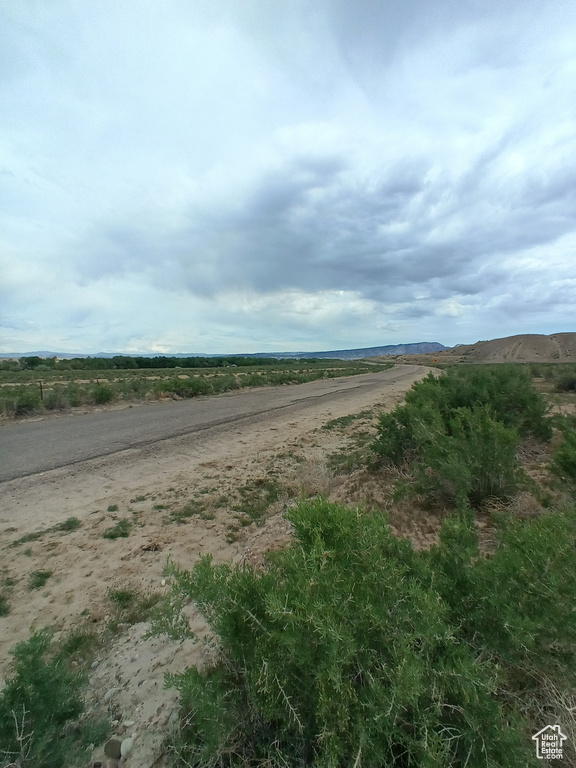 View of dirt / gravel road featuring a view of rural / pastoral area