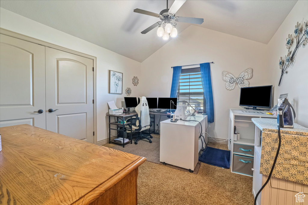 Carpeted office featuring ceiling fan, lofted ceiling, and baseboards